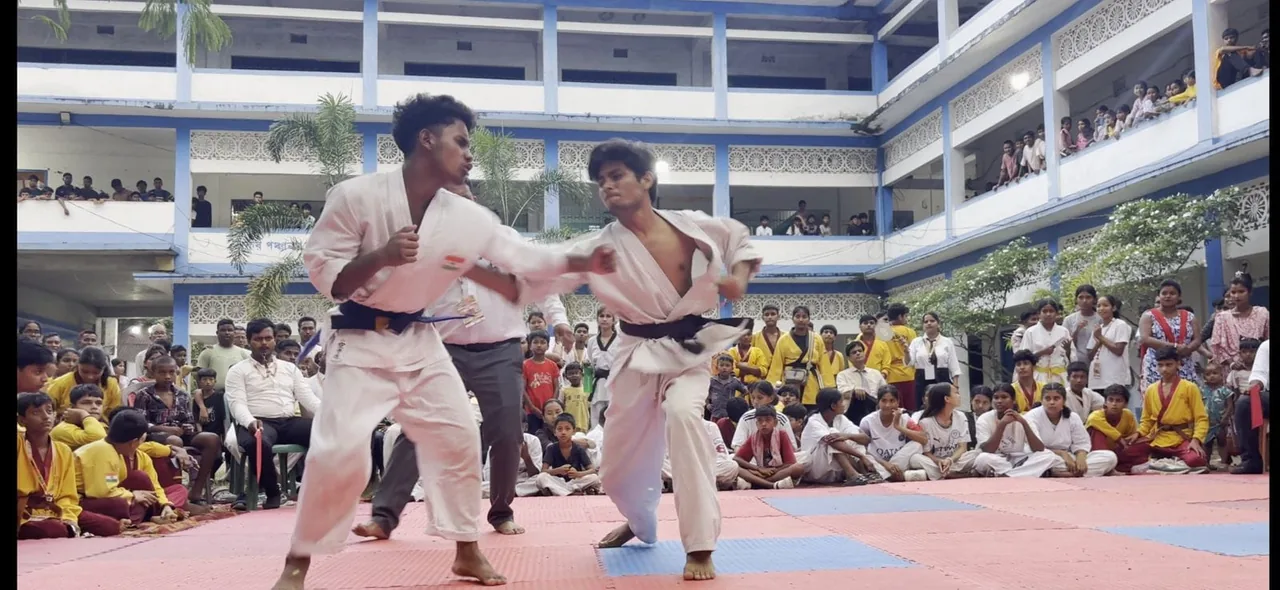 Karate participants practising in a competition setting
